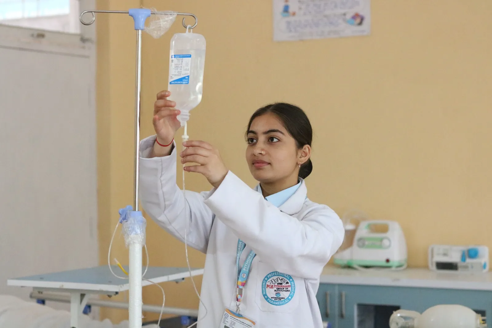 A nursing student setting up an intravenous line in the skills laboratory at PGI Pithoragarh